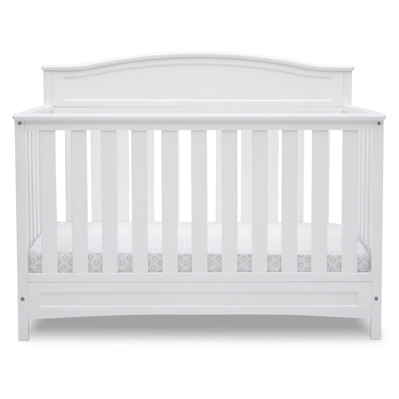 white delta children emery convertible crib with an arched headboard and slatted sides