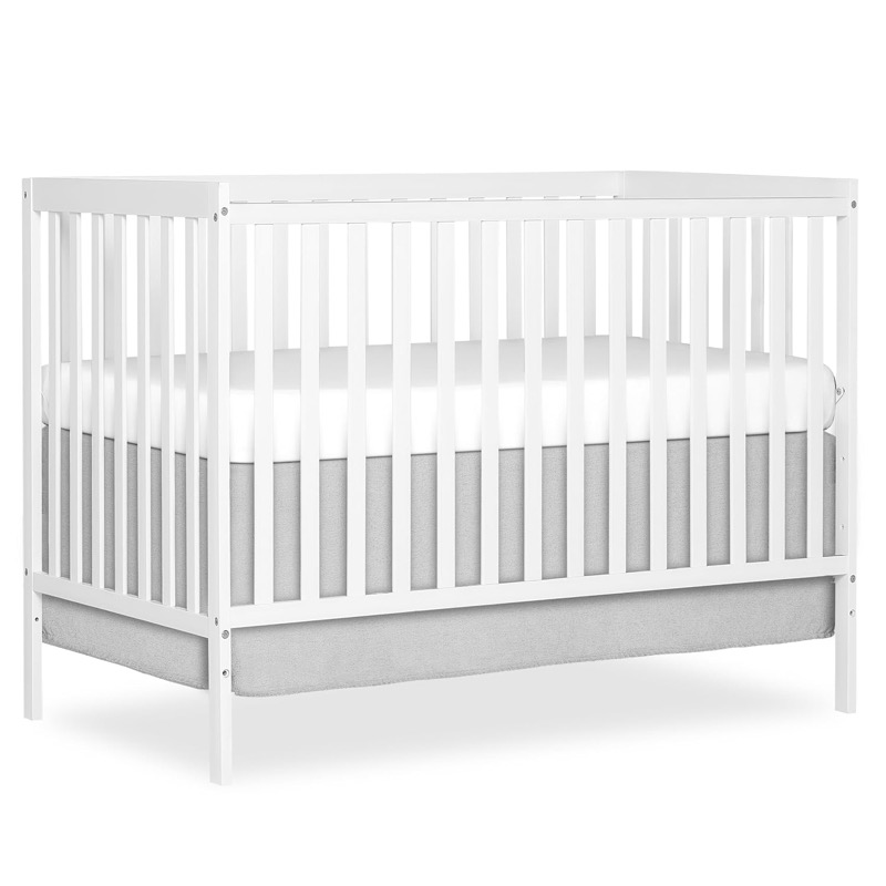white dream on me synergy convertible crib with a scalloped headboard and slatted sides
