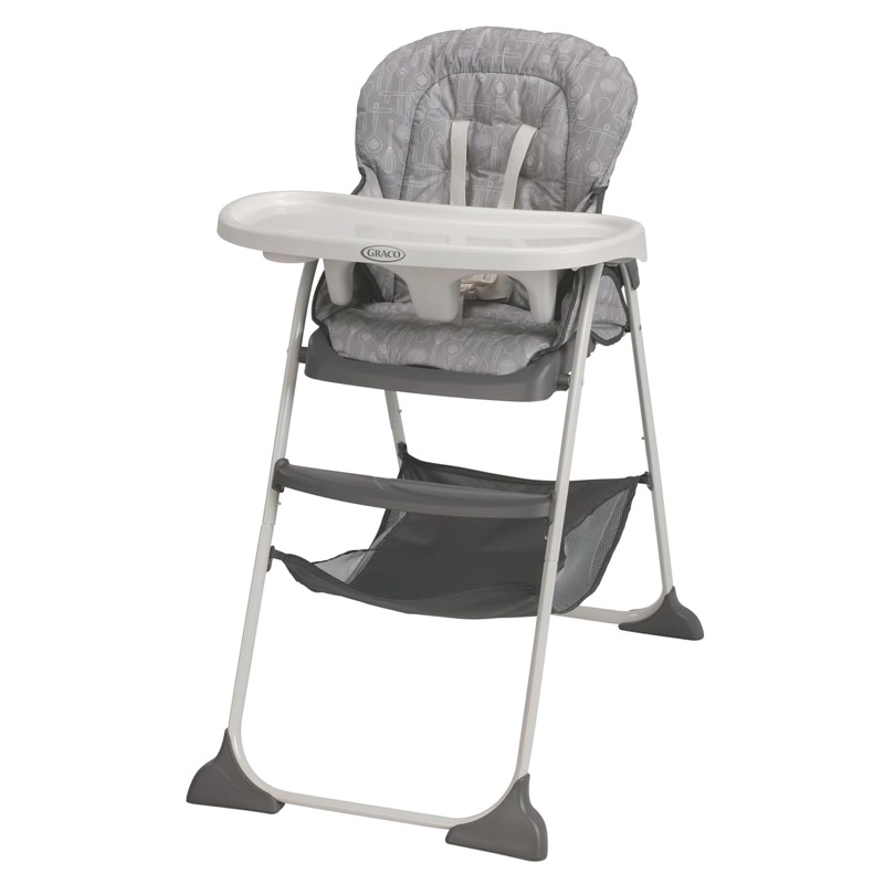 gray graco slim snacker folding high chair with a white tray and a storage basket under the seat