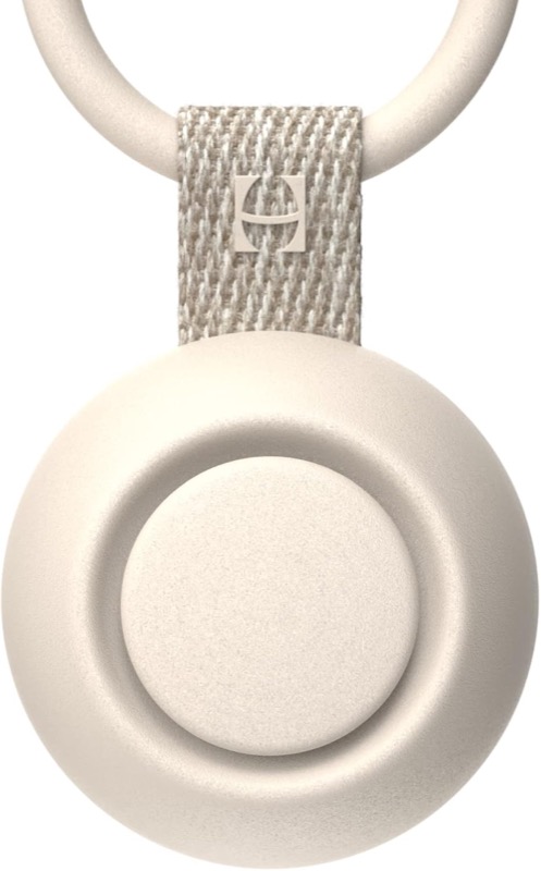 putty-colored round hatch go portable sound machine with a clip ring at the top