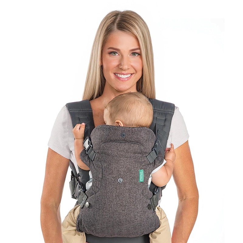 woman wearing a gray infantino flip carrier with a baby facing her chest