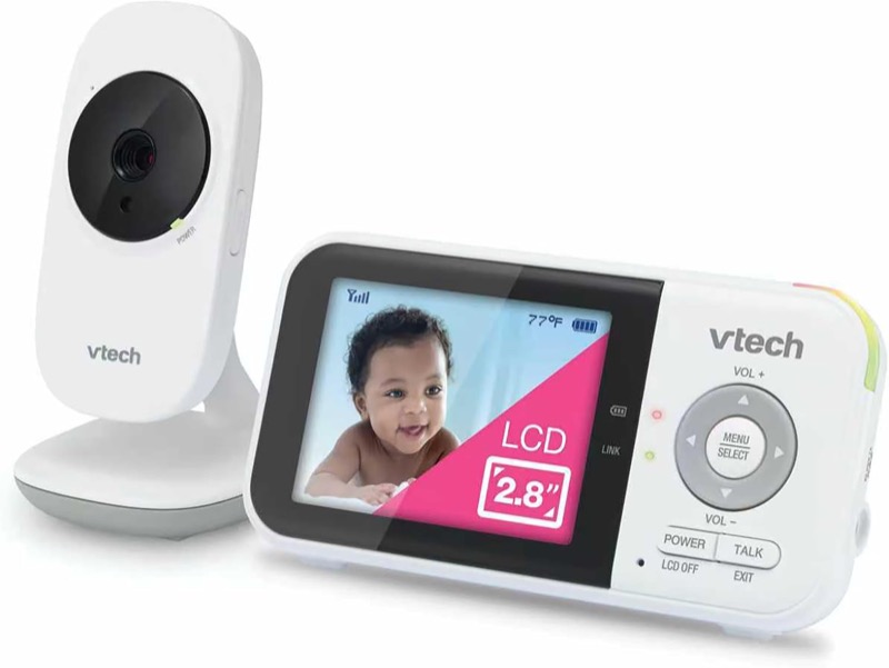 white vtech vm819 camera beside its small parent unit showing a baby on screen